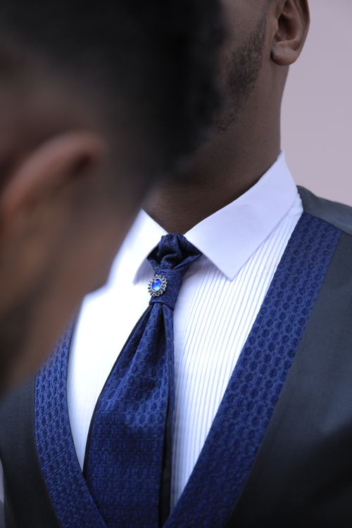 Free Crop anonymous African American man helping young friend in stylish elegant groom suit before wedding ceremony Stock Photo