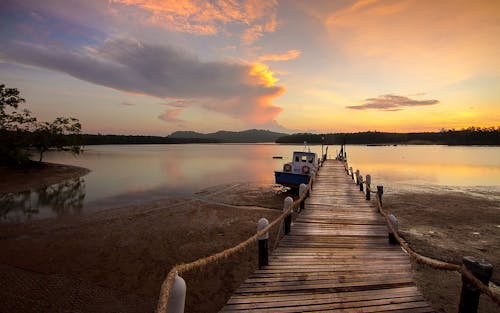 White Boat Beside Wooden Dock