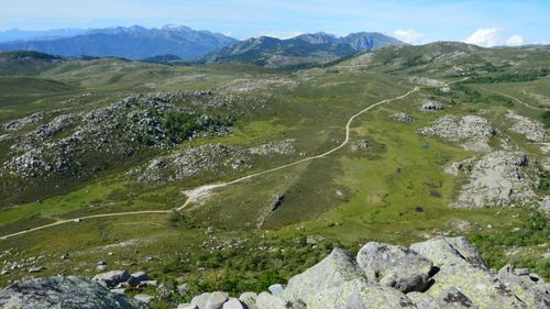 Free Expansive view of the rugged landscape and winding path in Aullène, Corse, France under a clear sky. Stock Photo