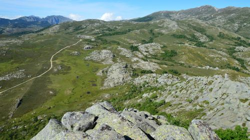 Free Breathtaking view of Corsica's rocky terrain and distant mountains under a clear sky. Stock Photo
