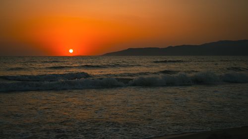 Free Stunning sunset view over the Aegean Sea in İzmir, Türkiye, with vivid orange hues. Stock Photo