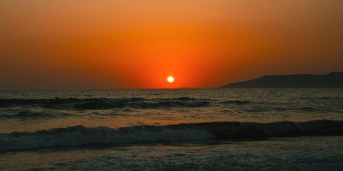 Free Breathtaking sunset over the Aegean Sea in İzmir, Türkiye, with vibrant orange hues. Stock Photo