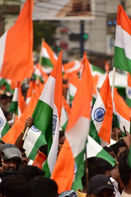Free Vibrant scene of people waving tricolor flags during Independence Day celebration in Ranchi, India. Stock Photo
