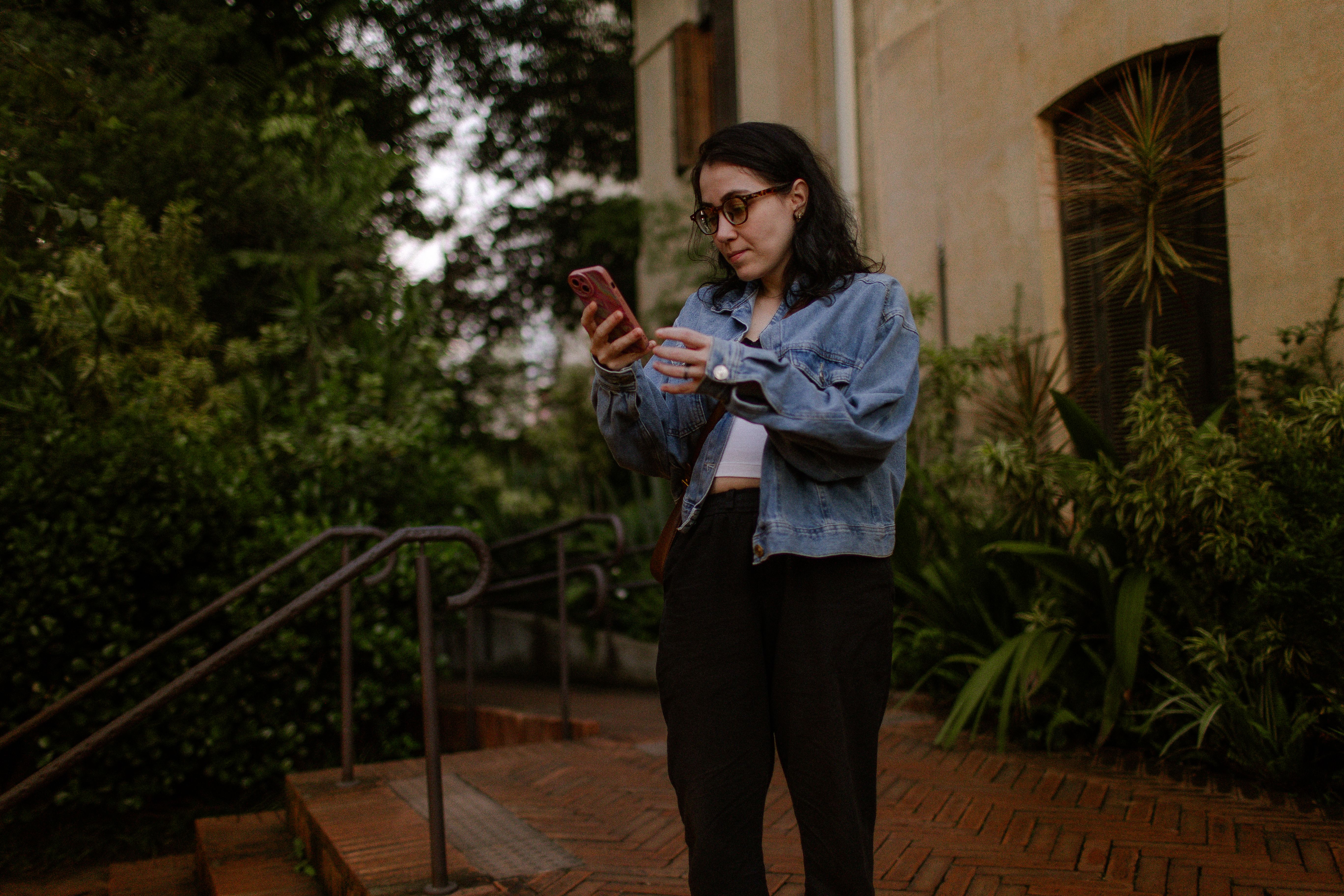 A user checking publisher details and app permissions on an Android phone before installing a card game