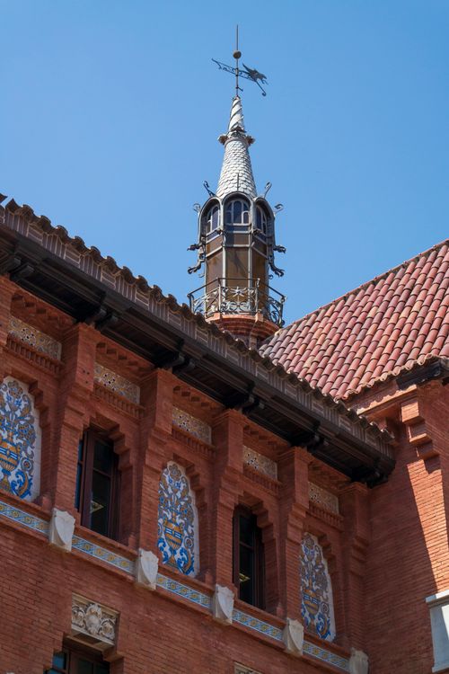 Free Intricate architectural details and spire on a historic brick building. Stock Photo