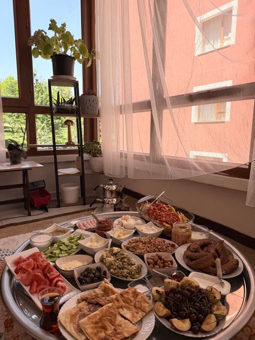Free Traditional Turkish breakfast spread in a sunlit Ankara room, complete with local delights and tea. Stock Photo