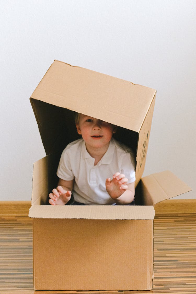 Boy Playing With Boxes