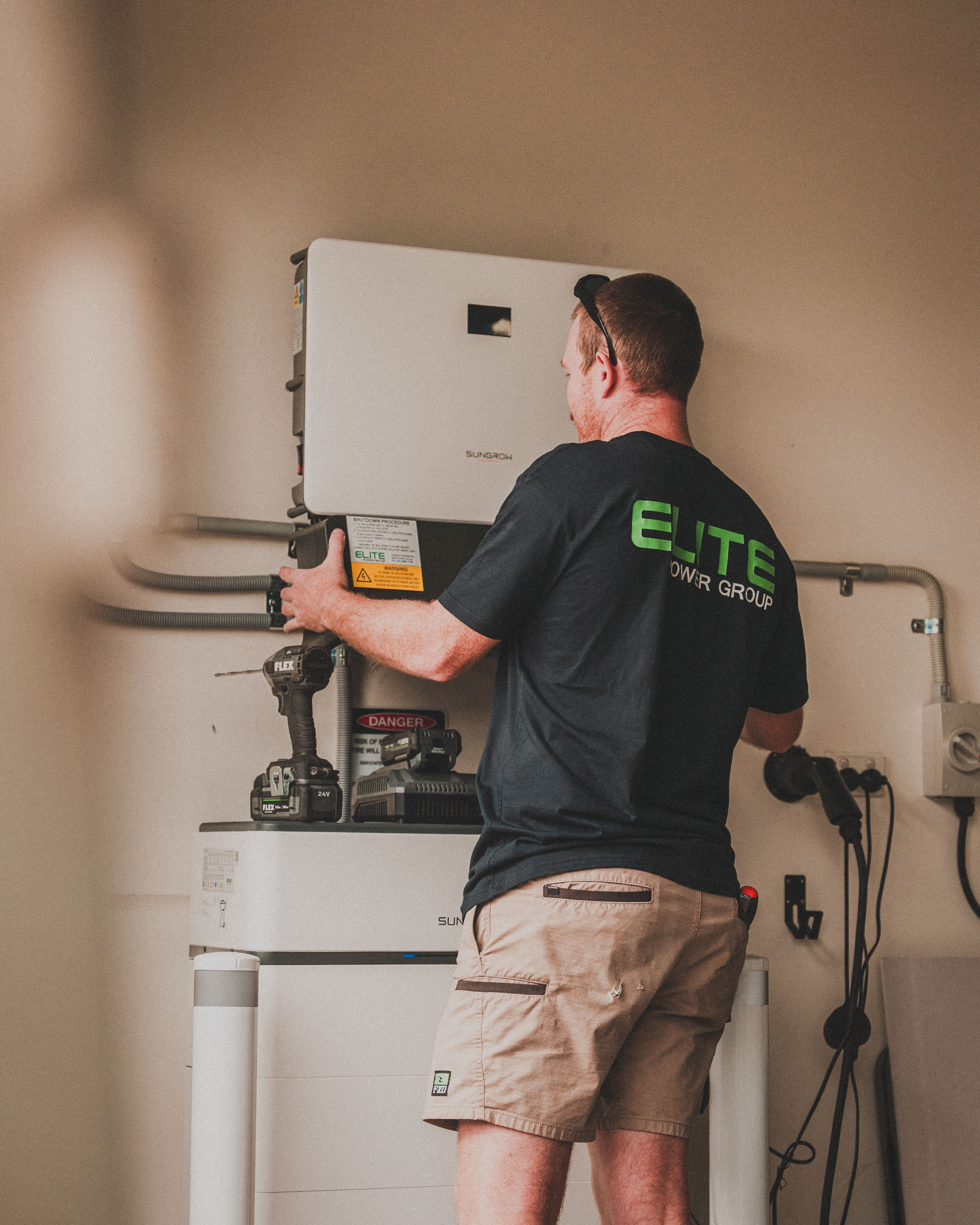 Expert technician installing a home solar battery system for energy storage.