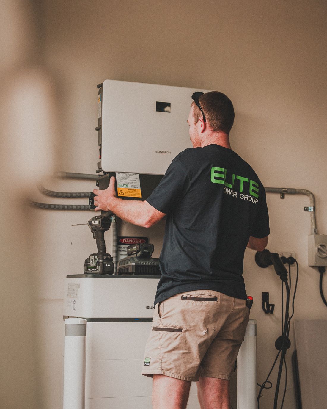Technician installing a home solar battery