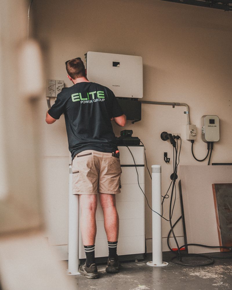 Technician working on a wall-mounted home battery storage system