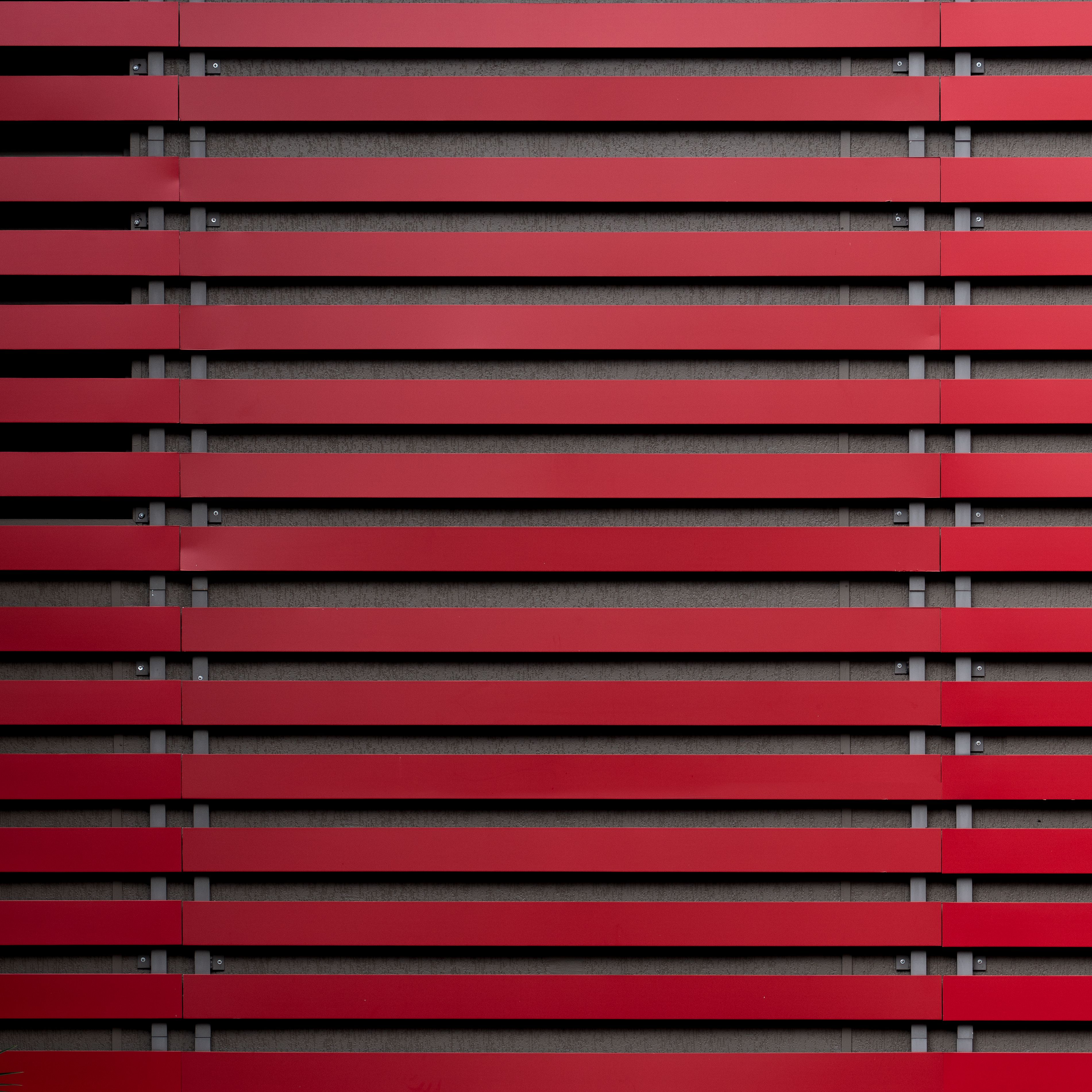 Explore this striking minimalist pattern with red horizontal lines on a gray backdrop, ideal for modern design concepts.