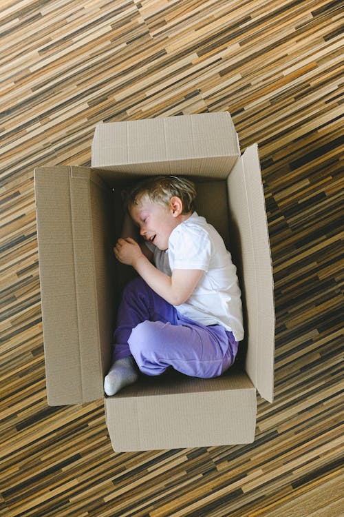 Boy In White T-shirt Inside A Box