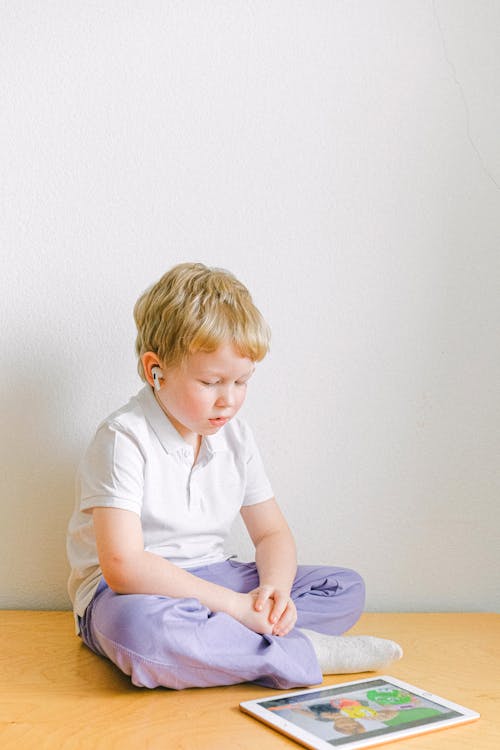 Boy In White Polo Shirt Sitting 