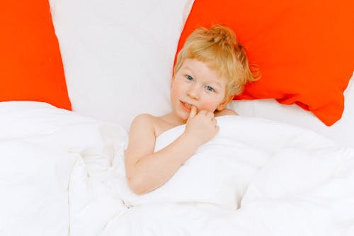 Free Topless Boy Lying On Bed Stock Photo