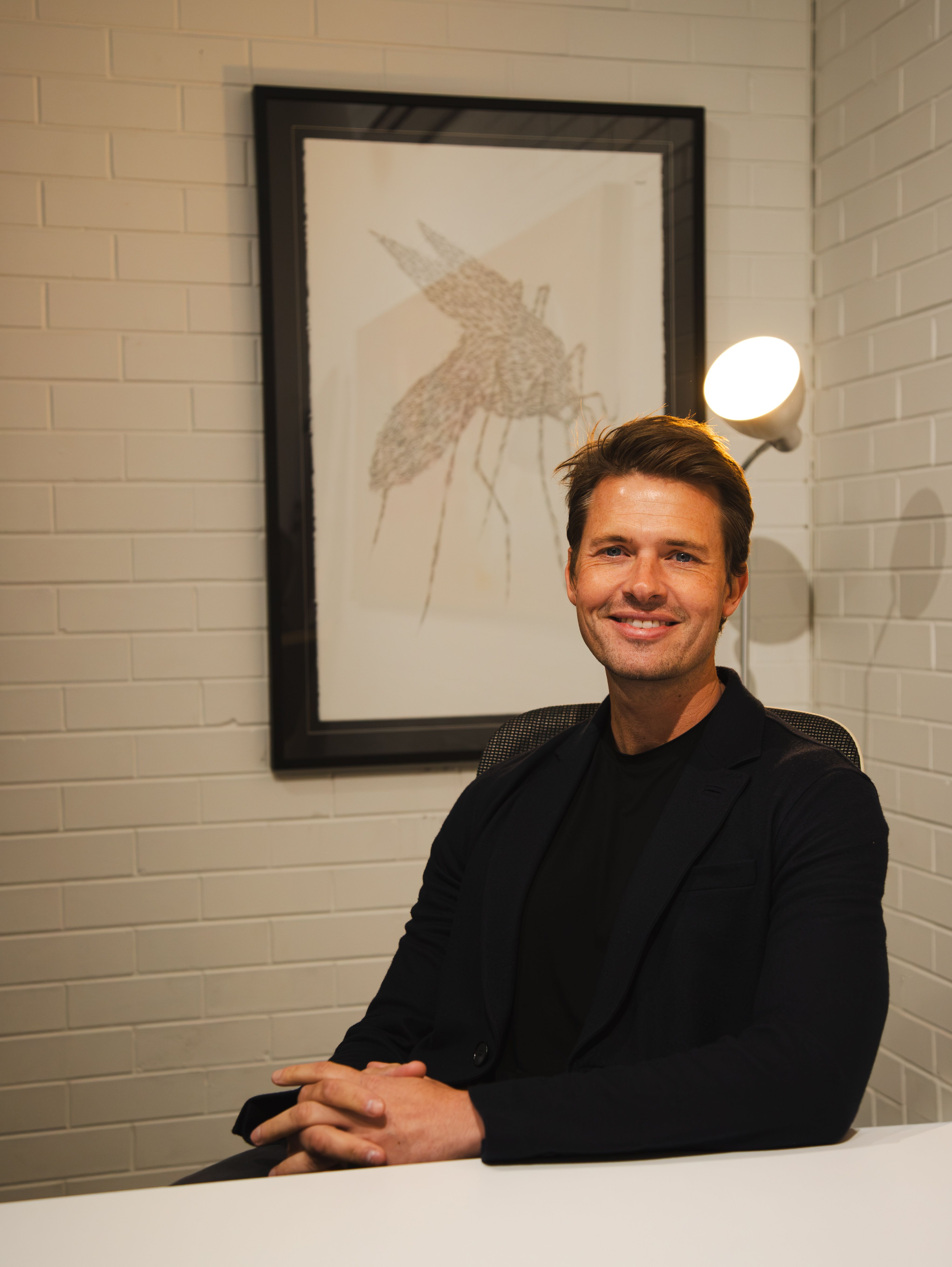 Portrait of a smiling businessman in an office setting, ideal for business and lifestyle themes.