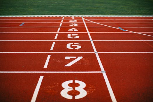 Close-up view of an athletic race track with numbered lanes, ready for competition.
