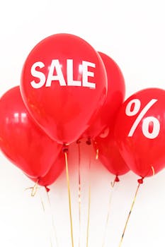 Bright red balloons with sale and percentage symbols for promotional advertising.
