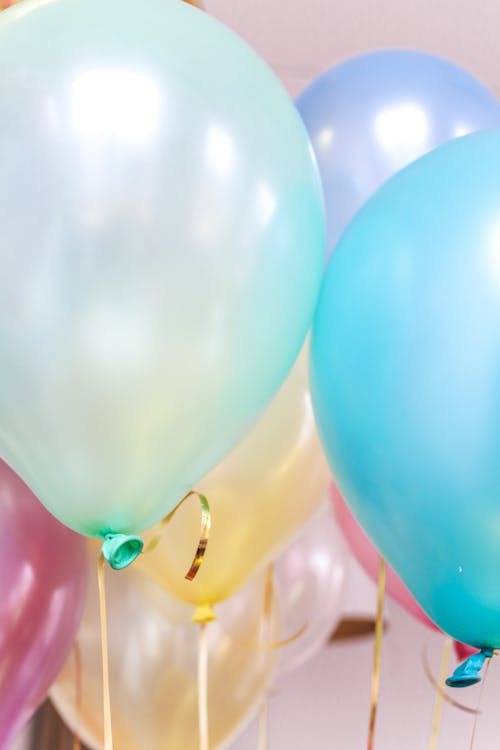 Close-up Photo of Pastel Colored Balloons