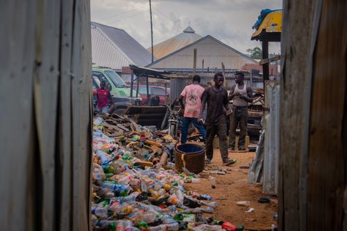 Free Young men sorting plastic bottles in an urban recycling center. Stock Photo