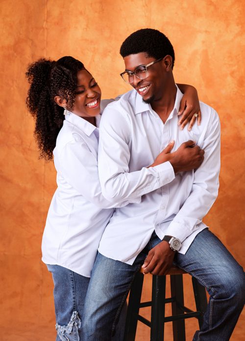 Free Smiling couple in white shirts embraces joyfully, showcasing happiness and style. Stock Photo