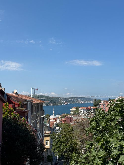 Free Picturesque view of Istanbul's Bosphorus Bridge over the water with cityscape and clear blue sky. Stock Photo