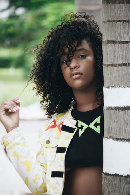 hair porosity: Woman Behind A Tree playing with hair