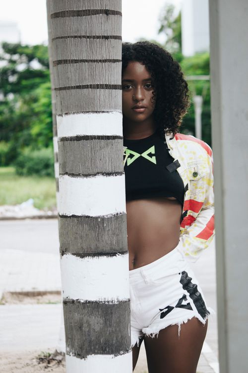 Free Stylish urban portrait of a young woman standing outdoors in Angola. Stock Photo