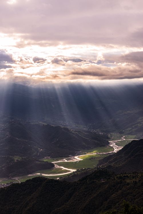 Free Breathtaking aerial view of Pokhara Valley, Nepal with dramatic sunrays piercing through clouds. Stock Photo