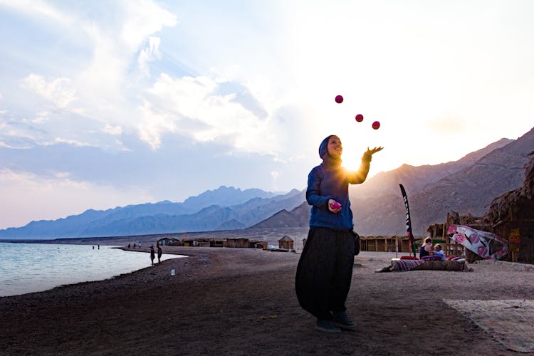 Woman At The Beach Juggling