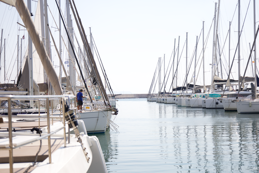 Serene view of sailboats docked in Athens, Greece under a clear sky. Perfect for travel inspiration.