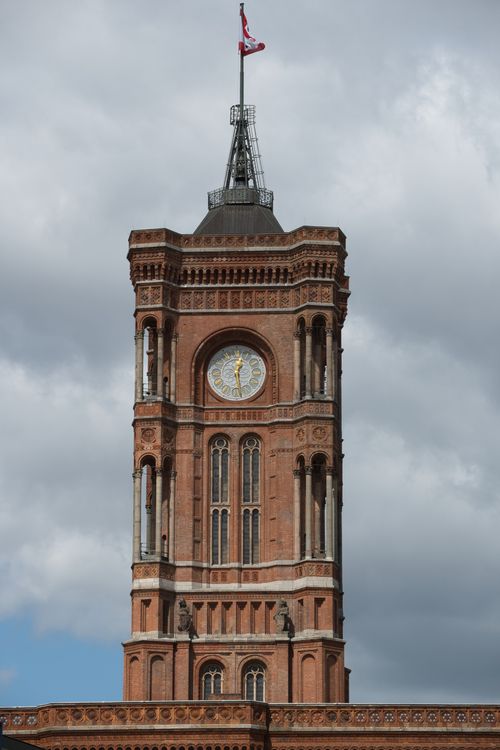 Free View of the historic Rotes Rathaus clock tower in Berlin with a cloudy sky backdrop. Stock Photo