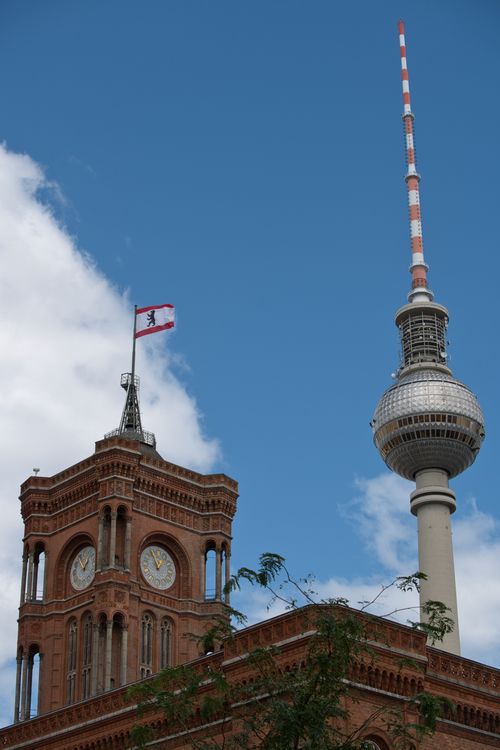 Free Iconic Berlin landmarks, the TV Tower and Rotes Rathaus, under a clear blue sky. Stock Photo