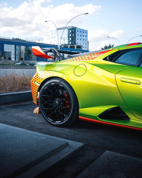 Free Bright green sports car parked in Ankara, Türkiye, showcasing modern urban architecture. Stock Photo