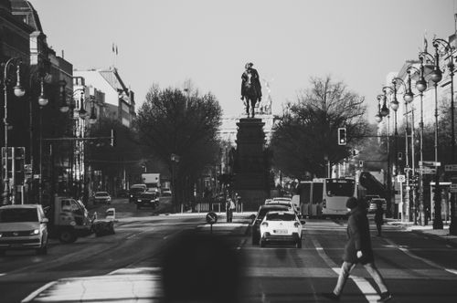Free Urban cityscape in black and white featuring a prominent equestrian statue. Stock Photo