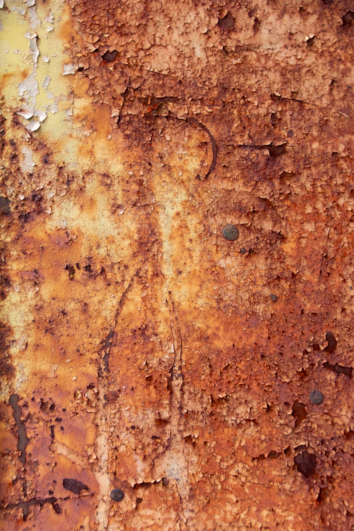 Rusted metal surface with peeling paint layers