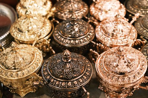 Free Close-up of intricately designed gold and bronze metal vessels with ornate patterns. Stock Photo