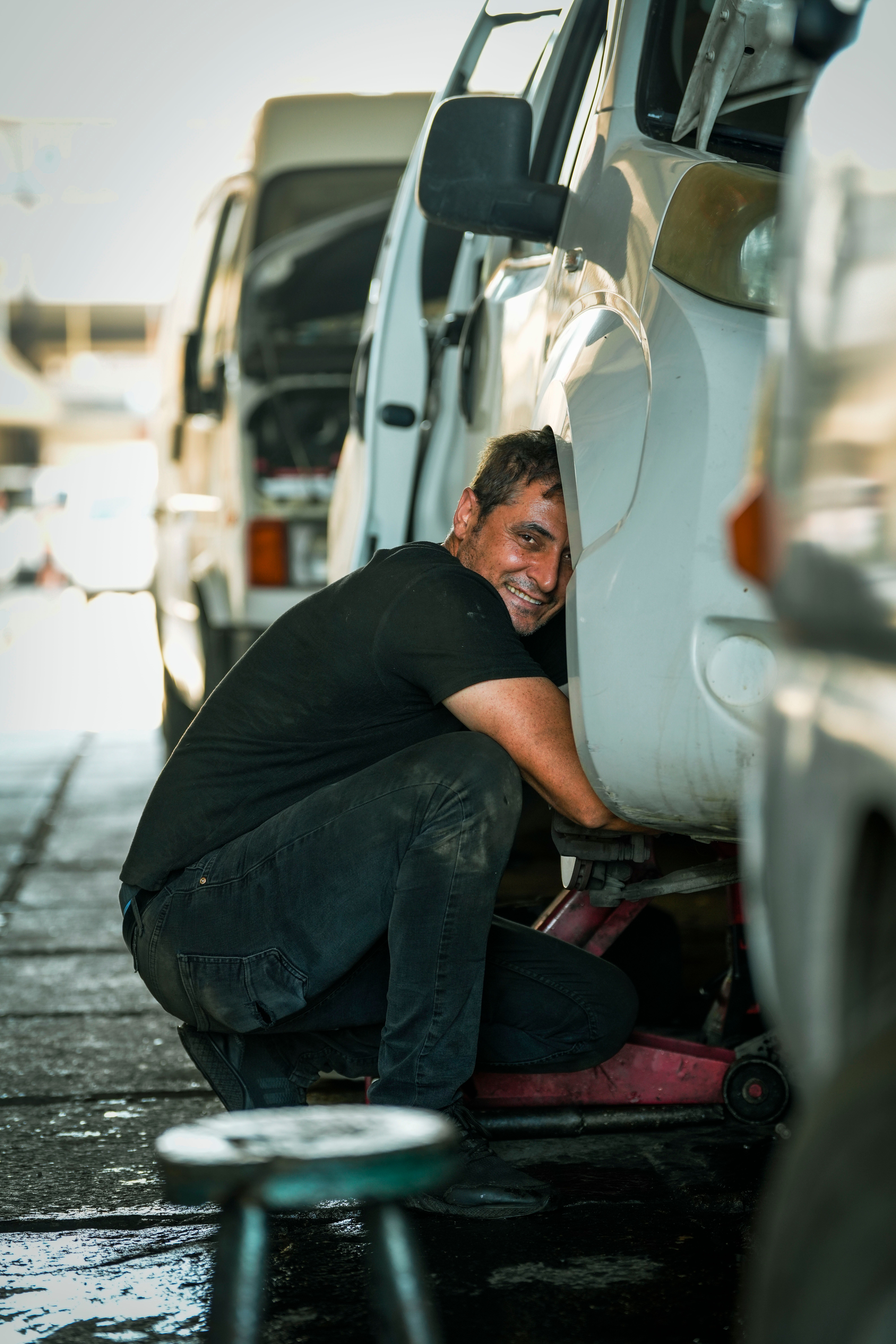 Mechanic standing beside a car with tools
