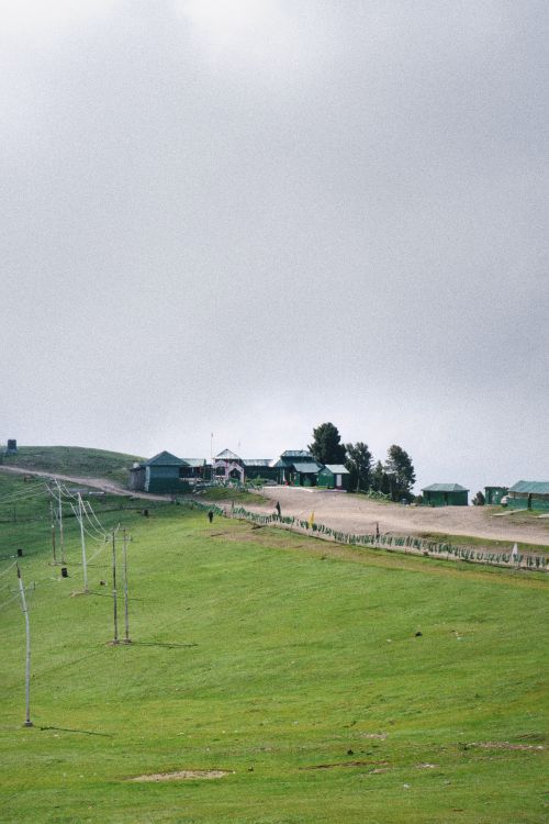 Free Breathtaking view of lush green hills in Kashmir with blue sky and clouds. Stock Photo