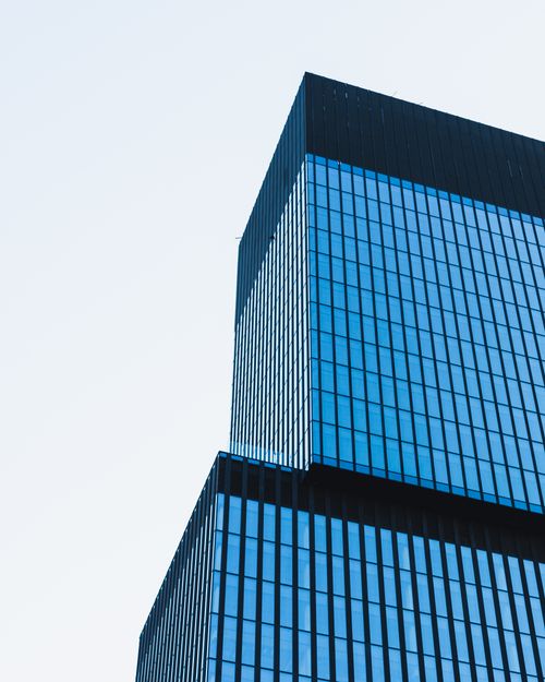 Free An architectural shot of a minimalist glass building in Katowice, Poland, exhibiting modern design. Stock Photo