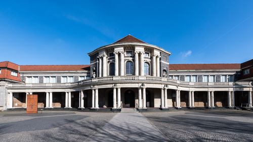 Free A striking view of a historic university building in Hamburg with classic architecture under a clear blue sky. Stock Photo