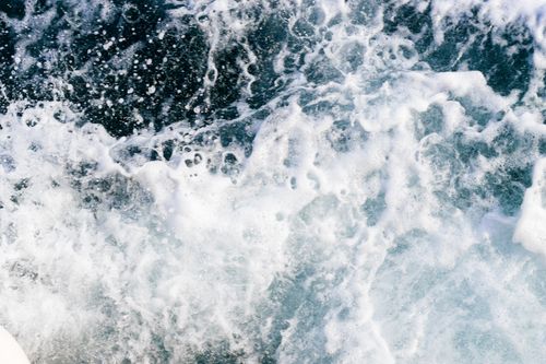Free High-angle view of powerful ocean waves and white foaming water splashes in motion. Stock Photo