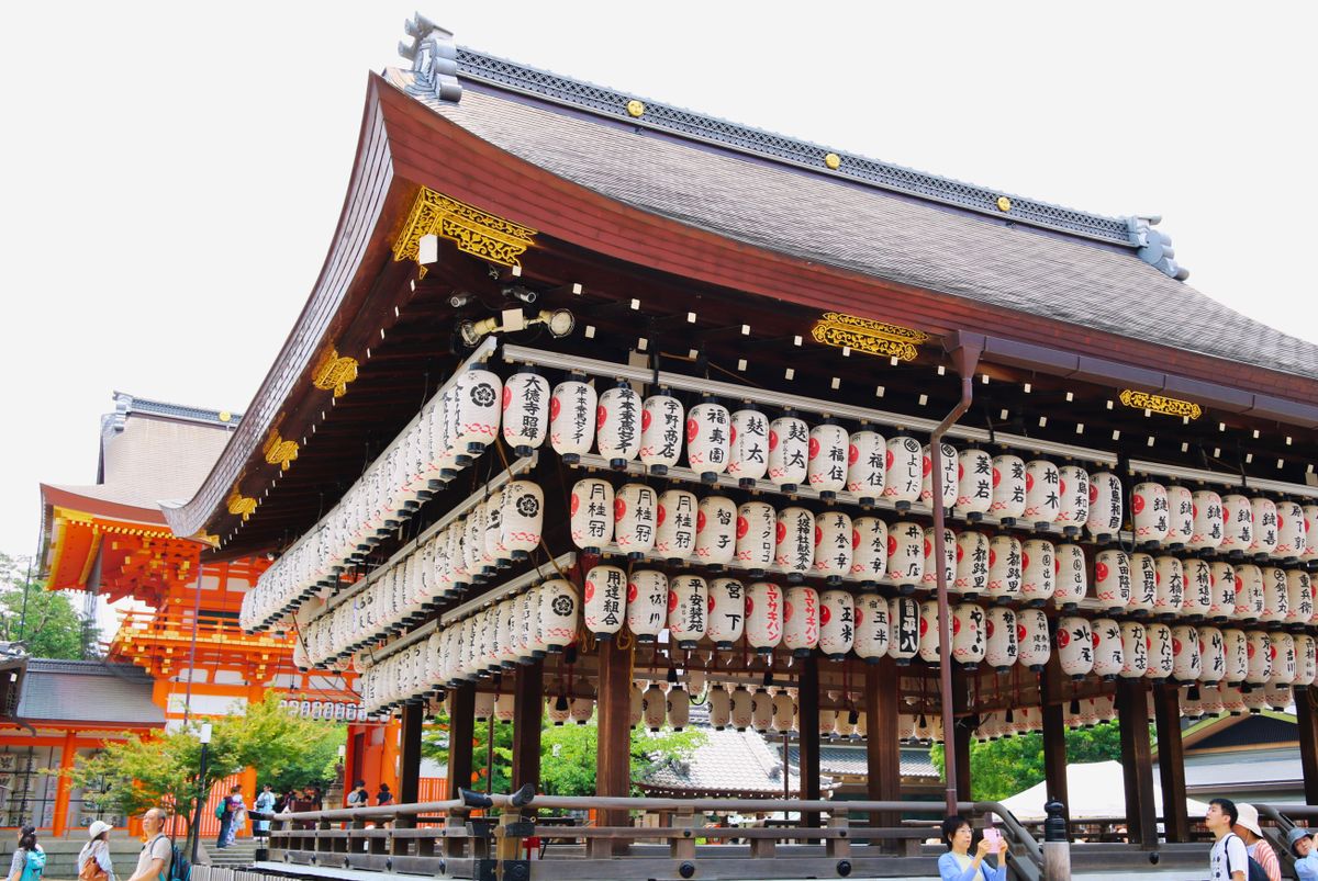 The lantern-covered dance stage at Yasaka Shrine in Kyoto, with vermilion shrine buildings behind