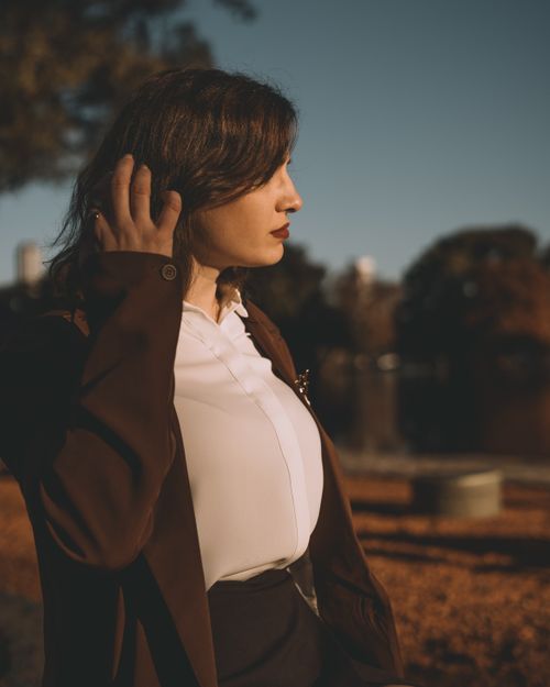 Free Stylish woman in a park setting during golden hour in Buenos Aires, Argentina. Stock Photo