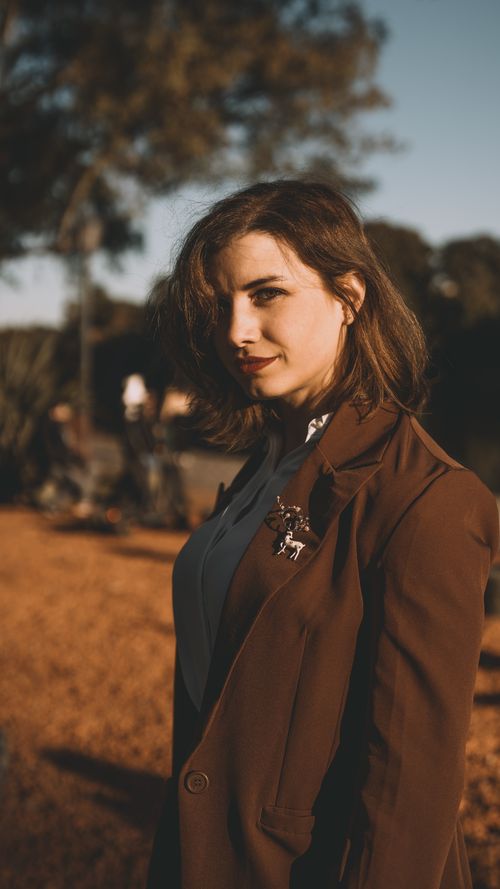 Free A fashionable woman poses in a park during autumn in Buenos Aires, Argentina. Stock Photo