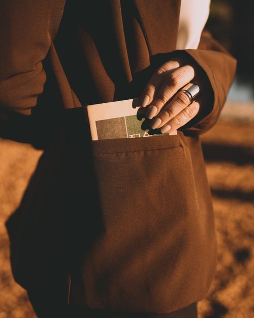 Free Stylish individual in Buenos Aires with book in pocket, warm sunlight. Stock Photo