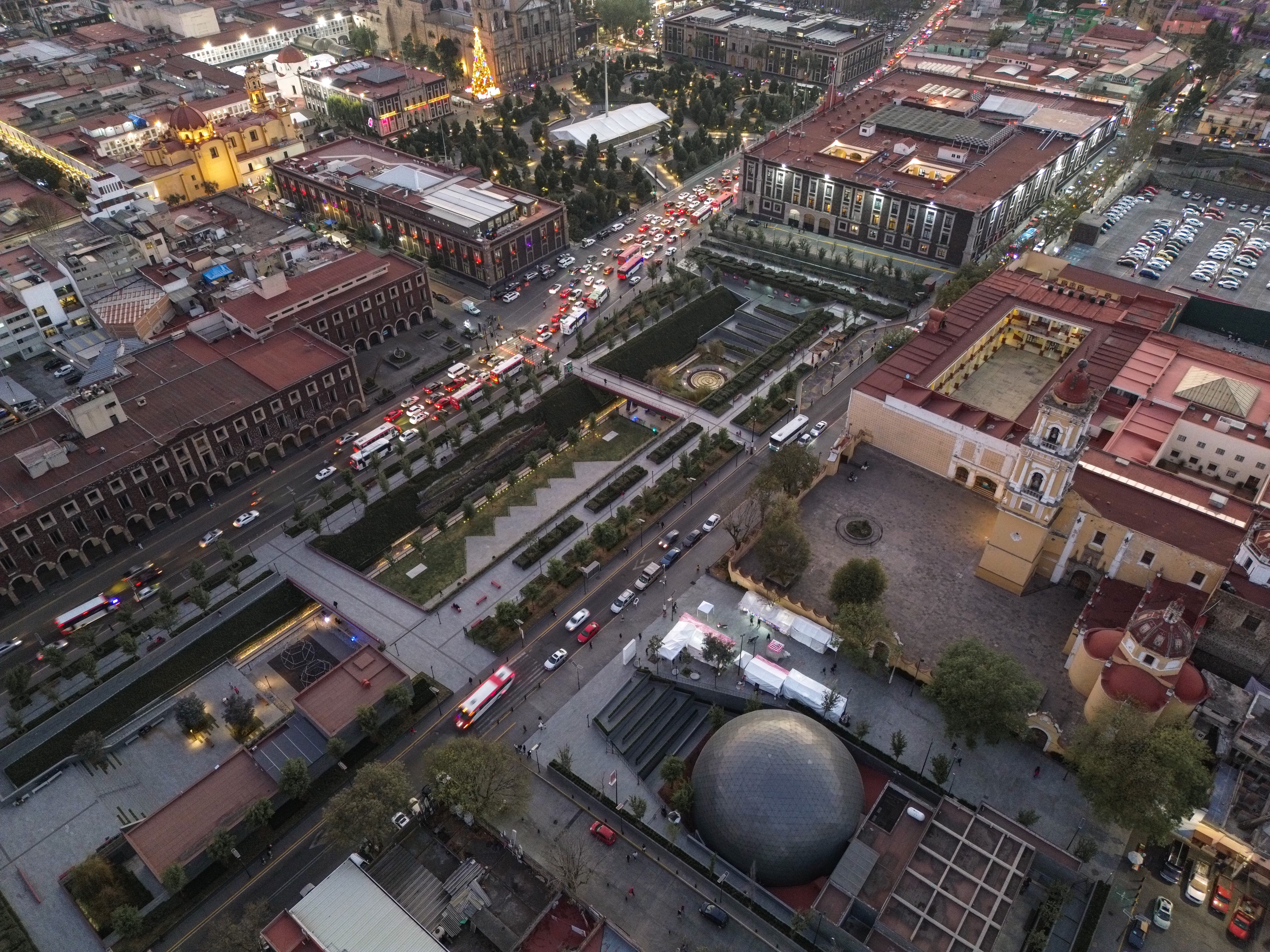 Stunning aerial view of Toluca city center at twilight, showcasing vibrant architecture and bustling streets.