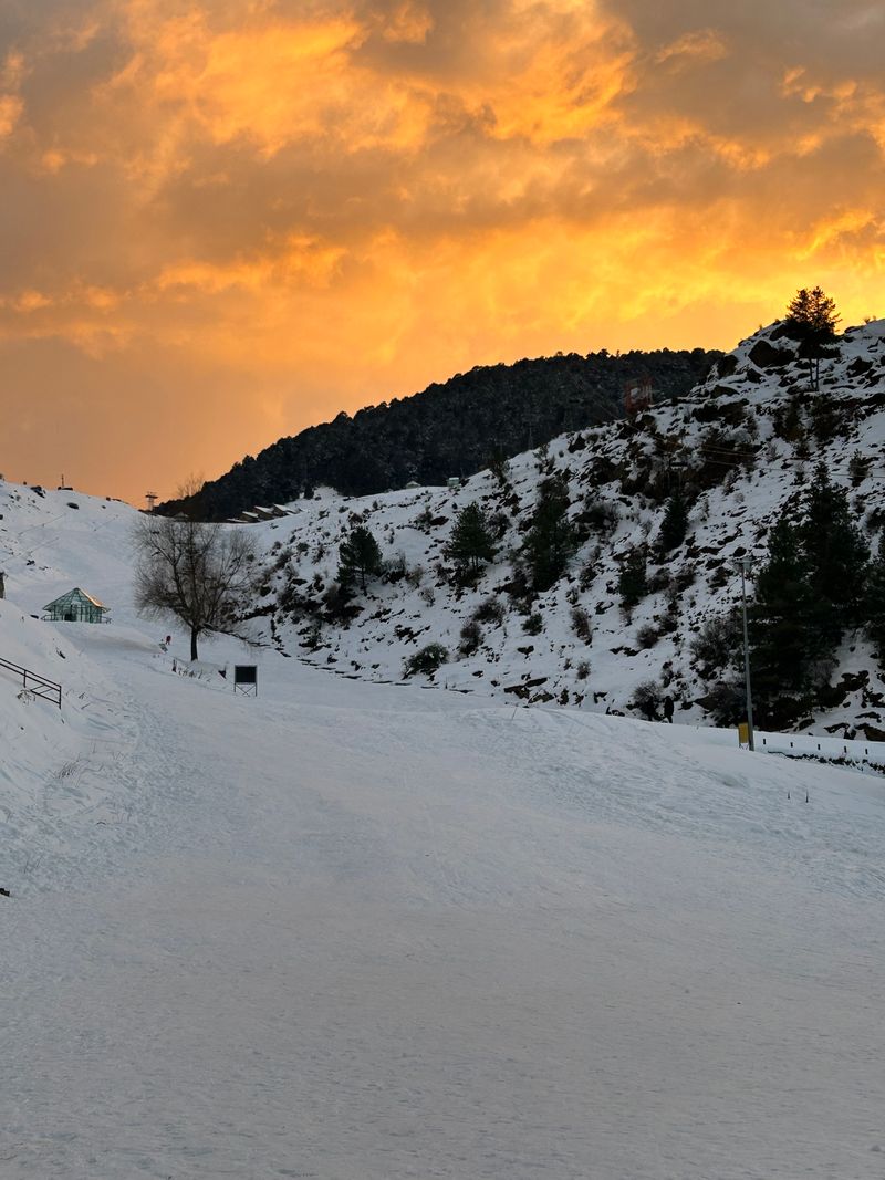 Snow-covered mountains at sunset in Auli