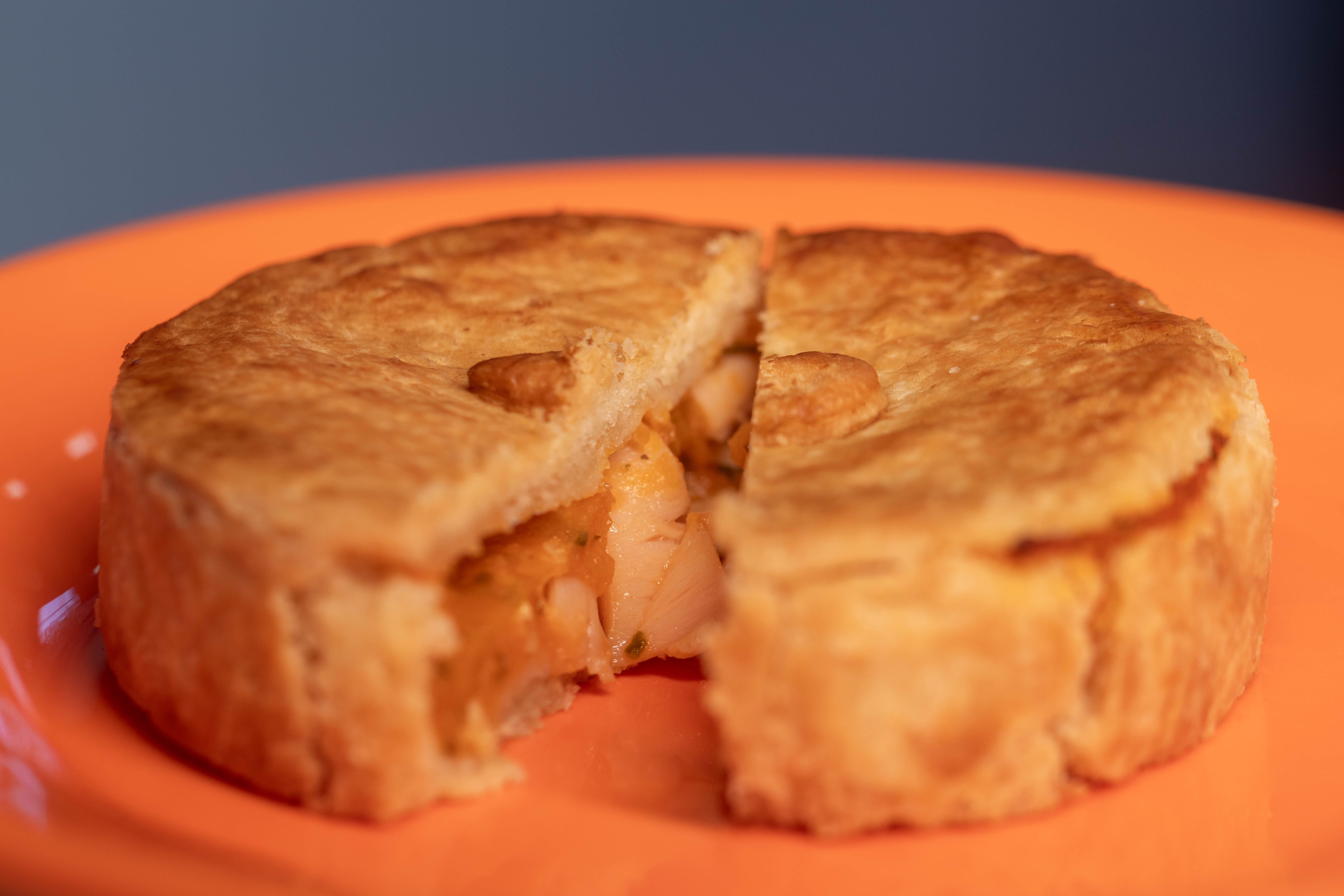 A chicken pot pie sliced open showing the filling