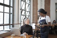 Woman in Black Long Sleeve Shirt Sitting on Chair
