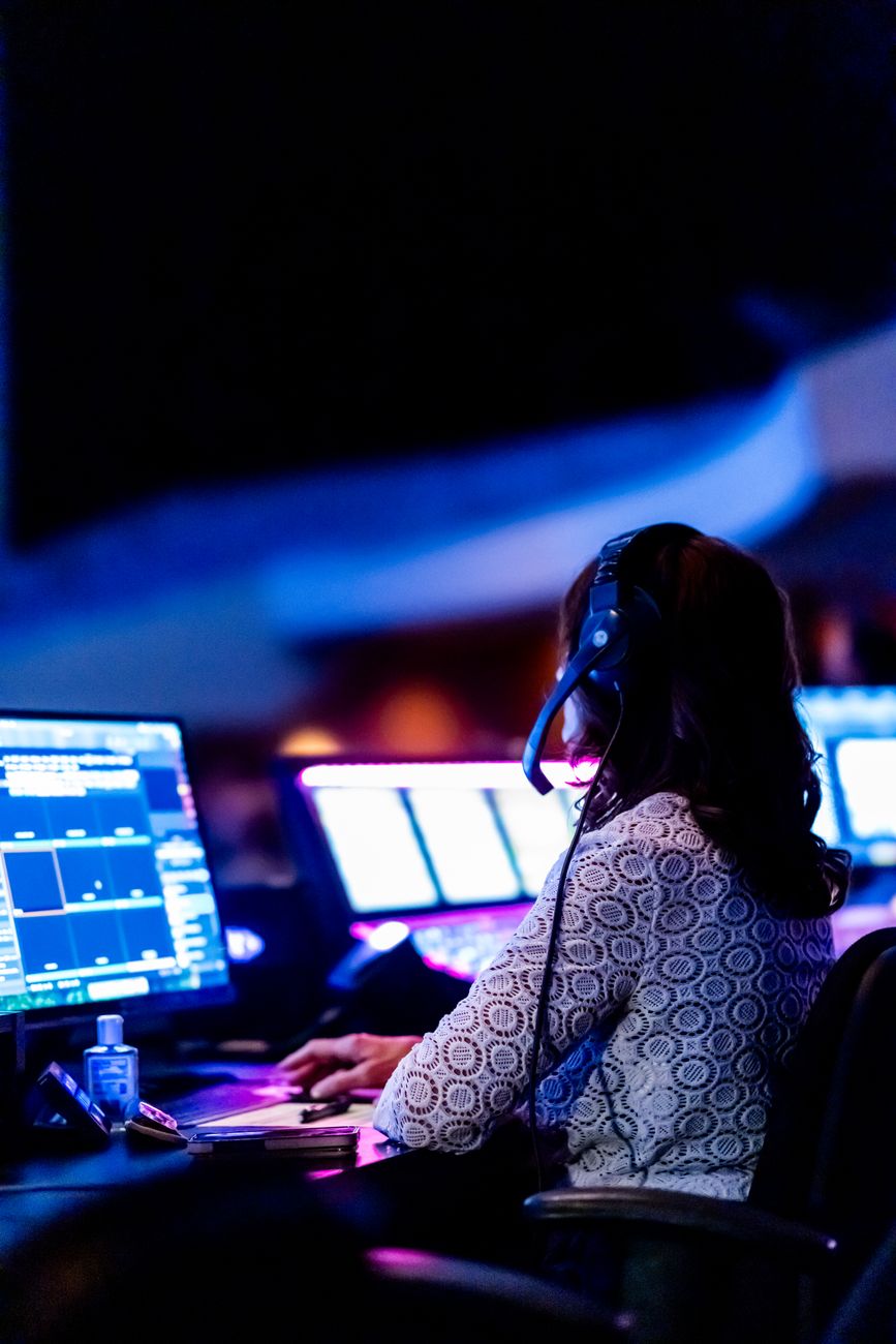Operations engineer monitoring systems across multiple screens
